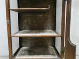 an old wooden cabinet with a mirror on top of it