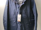 the jacket is hanging on a hanger on the wall
