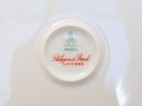 a white plate with a red and green design on it
