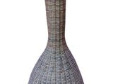 a wicker vase that is sitting on a white surface