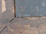 a piece of wood that has been torn off and has a red dot on it