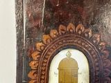 a wooden frame with a clock in it on a table