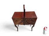 a small wooden table with a drawer on top of it