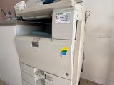 une imprimante blanche posée sur un meuble blanc