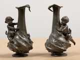 two vases that are sitting on a table