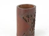 a small wooden cup with a carved design on it