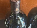 two bottles of wine that are sitting on a table