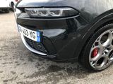 a close up of a black car parked in a parking lot