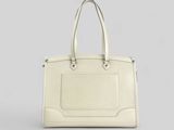 a white handbag on a grey background with a white background