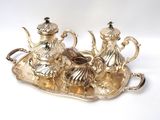 a silver tray with a silver tea set on it