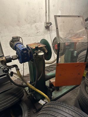a machine that is working on a tire in a garage