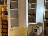 a kitchen with a refrigerator and shelves in it