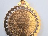 a gold coin that is sitting on a white surface