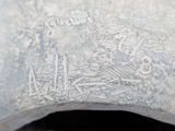 a close up view of a piece of metal with writing on it