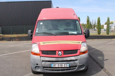 a red van that is parked in a parking lot