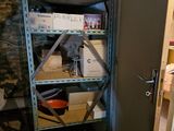 a shelf with boxes on top of it in a room
