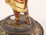 a figurine of a woman holding a sword on a pedestal
