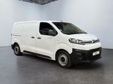 the white van is parked in the large room of the building