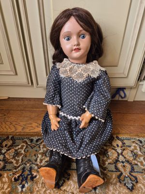 a doll that is sitting on a rug on the floor