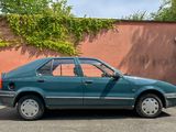 a blue car that is parked in front of a wall