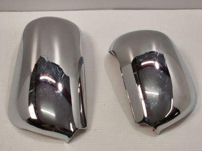 two chrome mirrors on the side of a white table