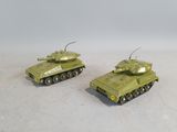 two toy tanks sitting side by side on a white surface