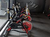 a lot of bikes that are parked in a room