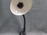a lamp that is sitting on a stand on a gray background