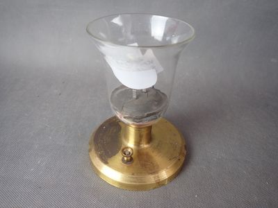 un petit verre contenant un bout de papier, posé sur une table