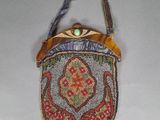 an image of a small beaded purse hanging on a wall