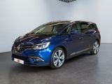 a blue car is parked in a large room with a ceiling fan