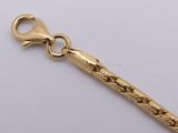 a gold chain that has a long handle attached to it