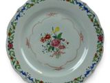 a plate with flowers on it on a white background