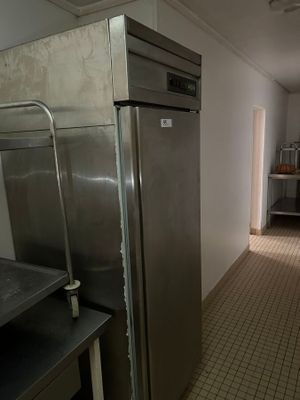 an image of a kitchen with stainless steel appliances and tile flooring