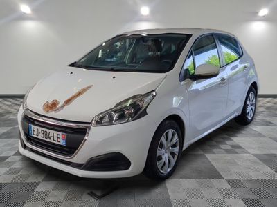 the small white car is parked in the garage with a checkered floor