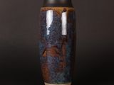 a vase that is sitting on a black surface