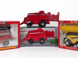 three toy trucks that are sitting in a box