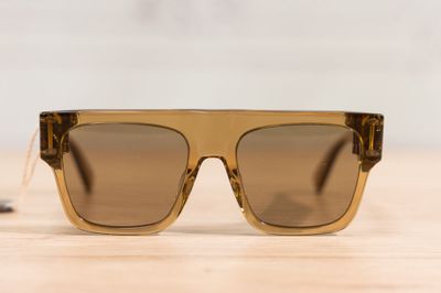 a close up of a pair of sunglasses on a wooden table