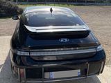 a picture of a black car parked in a parking lot