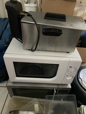 two microwaves stacked on top of each other on the floor