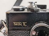 a close up of a black camera with a black strap