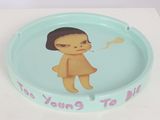 a blue ashtray with a picture of a girl smoking a cigarette