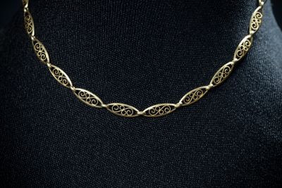 a gold necklace on a mannequin mannequin mannequin mannequin mannequin mannequin mannequin mannequin mannequin