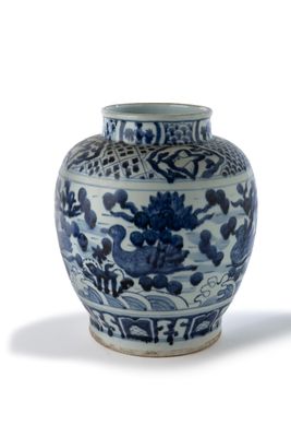 un vase bleu et blanc posé sur une surface blanche