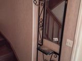a metal shelf with a mirror on it in a room