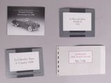 four business cards of different sizes and colors are on a table