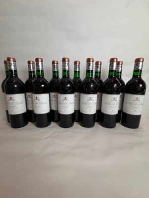 six bottles of wine are lined up in a row on a table