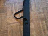 a black case sitting on the floor with a strap around it