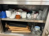 de nombreux bols et casseroles sur l'étagère de la cuisine