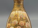 a gold vase with a lot of pictures on it